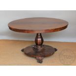 A William IV rosewood circular breakfast table, with octagonal baluster column,