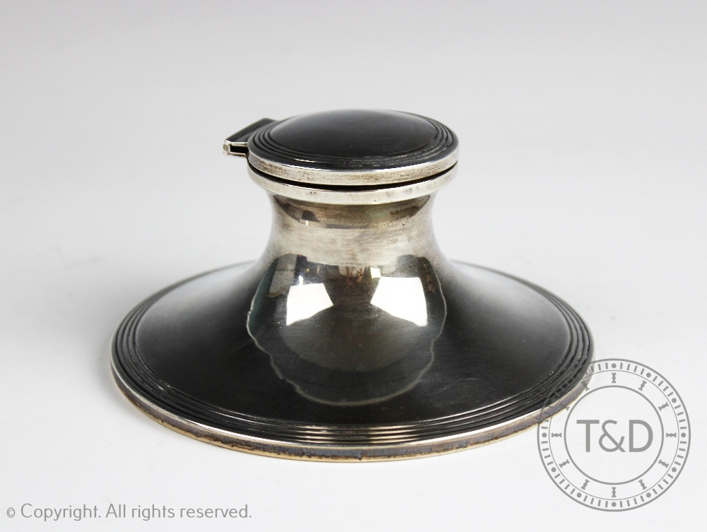 A George V silver capstan inkwell, Birmingham 1917, with blue glass liner and oak filled base,