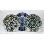 Two earthenware chargers decorated in an Iznik design in cobalt,