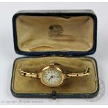 A ladies 9ct gold wristwatch, the Arabic numeral dial with a gilt and green foliate outer border,