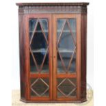 A Regency inlaid mahogany hanging corner cabinet,