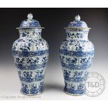 A large pair of Chinese blue and white baluster vases and covers,