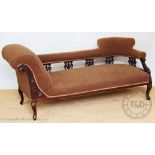 A late Victorian carved walnut scroll end chaise long, with brown upholstery, on cabriole legs,