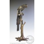 A modern Chinese bronze in the form of a parrot perched upon a branch, 59cm high,