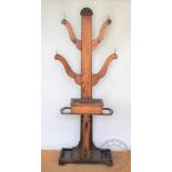 A 1920's oak hall stand, with six arms set with coathooks,