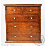 An Edwardian mahogany miniature apprentice chest, with two short and three long drawers,