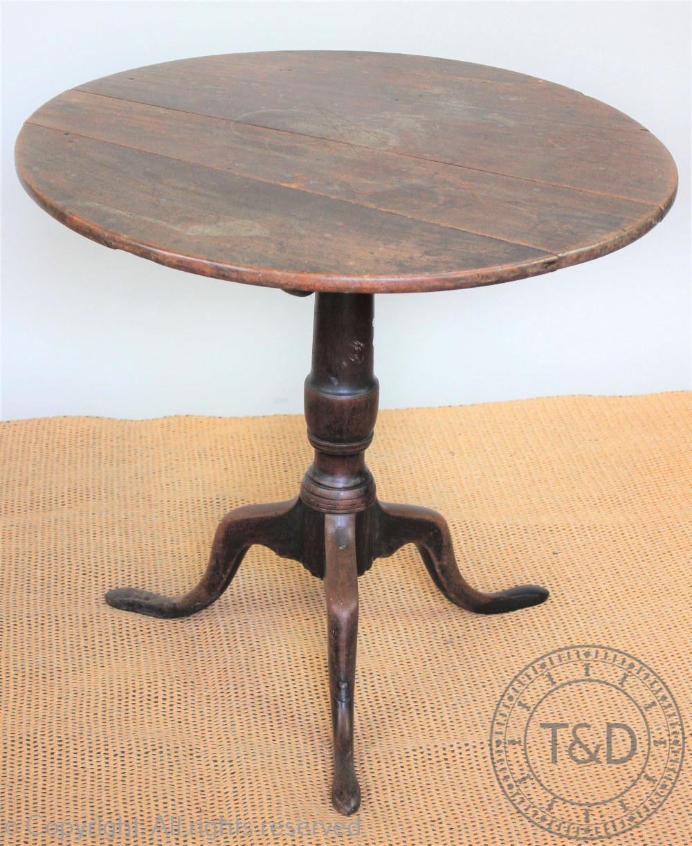 A George III mahogany occasional table, with circular top, on a turned column and tripod base,