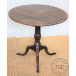 A George III mahogany occasional table, with circular top, on a turned column and tripod base,