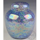 A Ruskin lustre glazed iridescent ginger jar and cover in a lavender colour way,