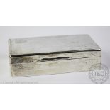 A George V silver cigarette box, London 1918, the top with engraved initials,