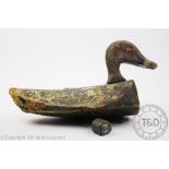 A Vintage early 20th century wooden decoy duck, with painted patina and lead weight,