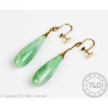 A pair of jade set drop earrings, each designed as a polished drop,