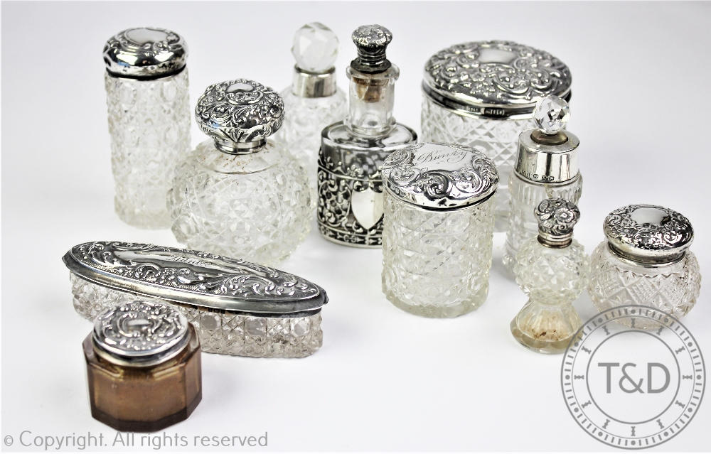 A collection of silver topped dressing table jars, Victorian and later,