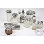 A collection of silver topped dressing table jars, Victorian and later,