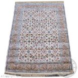 An ivory ground kashmir carpet, worked with an all over floral design against an ivory ground,