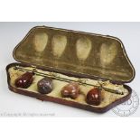 A set of brass and polished hard stone tapestry weights,