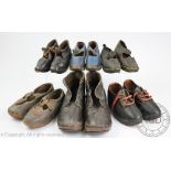 Four pairs of hand made children's leather clogs, wood soles with metal fittings,