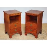 A pair of walnut bedside tables, late 20th century, each with a slide and two drawers,