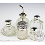 A selection of silver topped dressing table jars and bottles to include a cylindrical scent bottle,