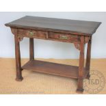 An Arts & Crafts oak side table, with two drawers and under tier, on block legs,