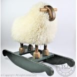 A vintage folk art sheepskin covered rocking sheep,