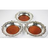 A set of three late Victorian silver plated bottle coasters,