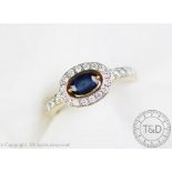 An untested sapphire and diamond ring, the central oval sapphire within a diamond set surround,