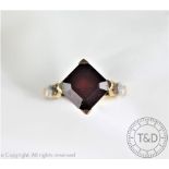 A garnet and diamond set dress ring,