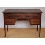 An Edwardian mahogany writing table, with four drawers, on tapered legs,