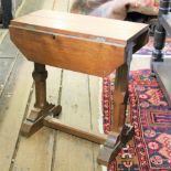 An Arts and Crafts style carved oak occasional table,