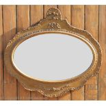 A late 19th century Prince of Wales oval gilt wood mirror,