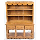 An apprentice oak dresser base and integral plate rack,