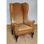 An 18th century style wing back library chair, late 19th / early 20th century,