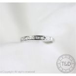 A diamond set 18ct white gold half eternity ring,