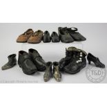 Three pairs of hand made children's leather shoes, two black and one tan pair,