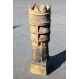 A tall crown top chimney pot,