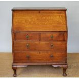 An Edwardian golden oak bureau, with fall enclosing a fitted interior,