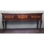 A George III style oak dresser, with three drawers above a shaped apron, on cabriole legs,