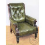 A late Victorian carved walnut library chair, with button back green leather upholstery,