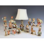 A collection of thirteen Goebel Hummel figures, including Little Drummer Trommler,
