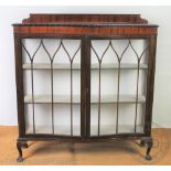 A 1920's mahogany bow front display cabinet, with two doors,