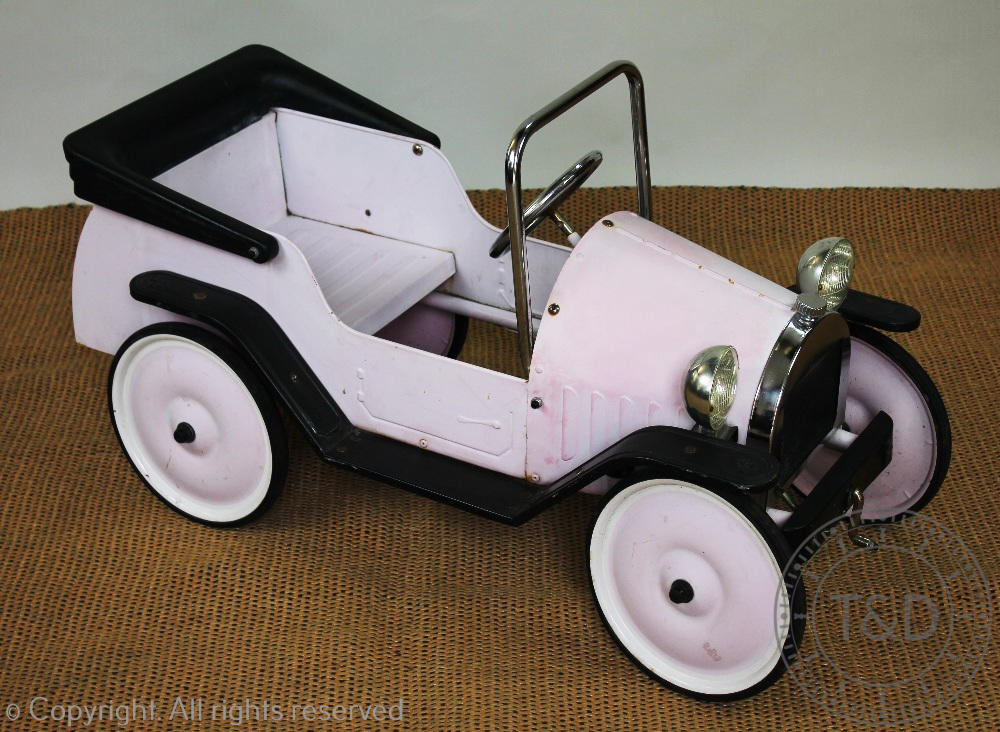 A French metal and plastic pink pedal car,