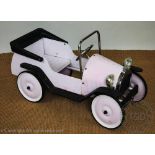 A French metal and plastic pink pedal car,