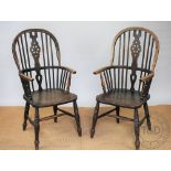 A near pair of beech, ash and elm wheel back Windsor type chairs, with solid seats, on turned legs,