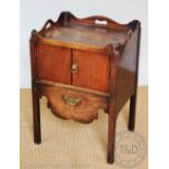 A George III mahogany tray top night commode, with two doors above a drawer with serpentine apron,
