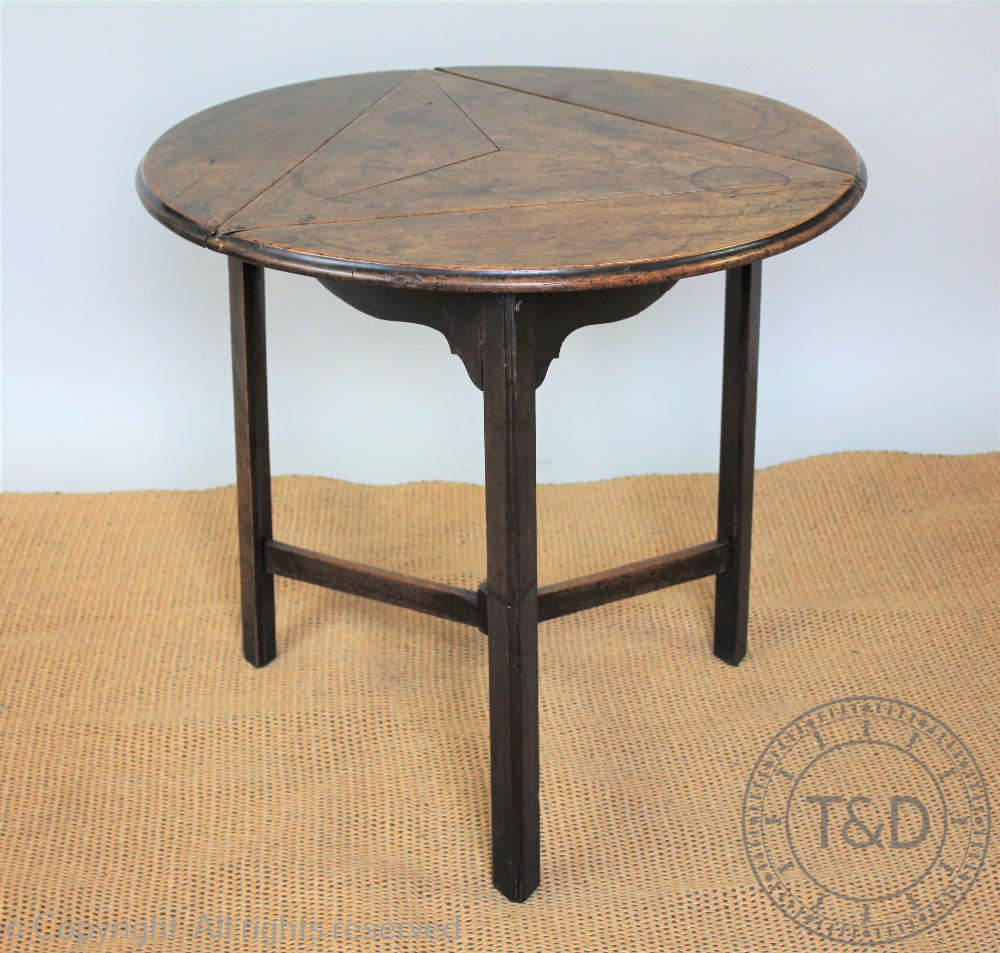 An early 19th century mahogany cricket type table, the rotating circular top with three leaves, - Image 2 of 3