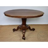 A Victorian mahogany oval loo table, with a tapered column, platform and scroll legs,