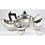 A silver bachelor's three piece tea service, Goldsmiths and Silversmiths Co Ltd, Sheffield 1884,
