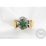 An emerald and diamond cluster ring,