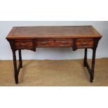 A late Victorian mahogany writing table, with three drawers, on turned legs,